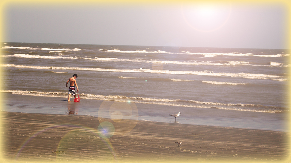 Shot with Canon appears that there is a lone child playing on the beach in Galveston, but it was just chance that no people were standing around him.